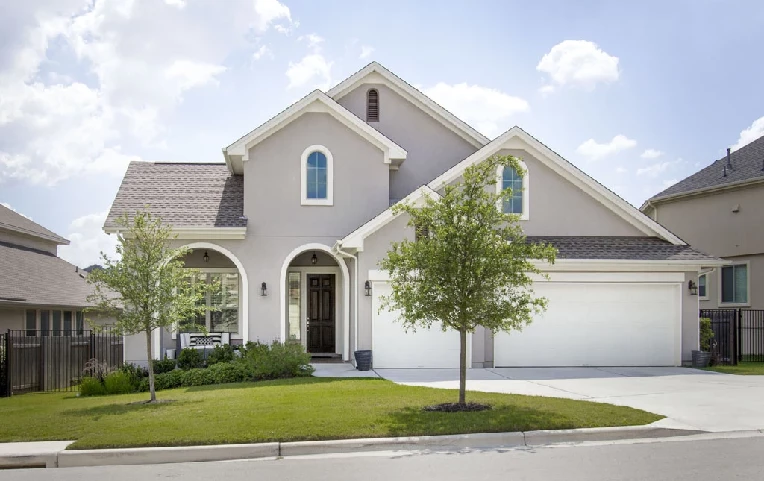 picture of a one and a half story stucco home represneting a modern day residence